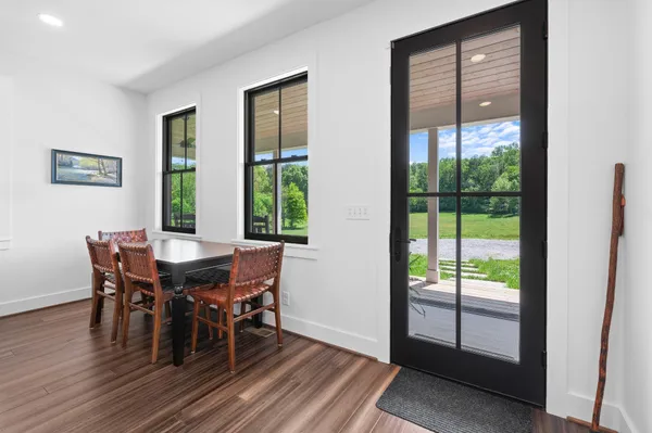 a bedroom with double bed windows and a rug