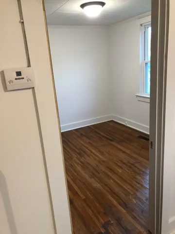 a view of a room with wooden floor