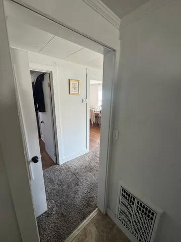 a view of hallway with mirror and door