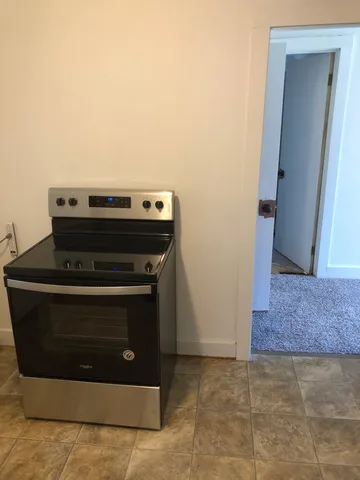 a stove top oven sitting inside of a kitchen