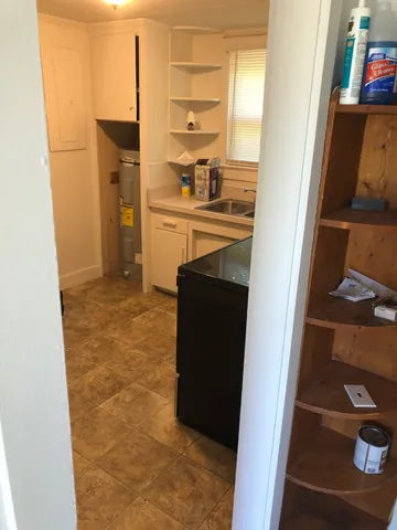 a kitchen with a refrigerator and cabinets
