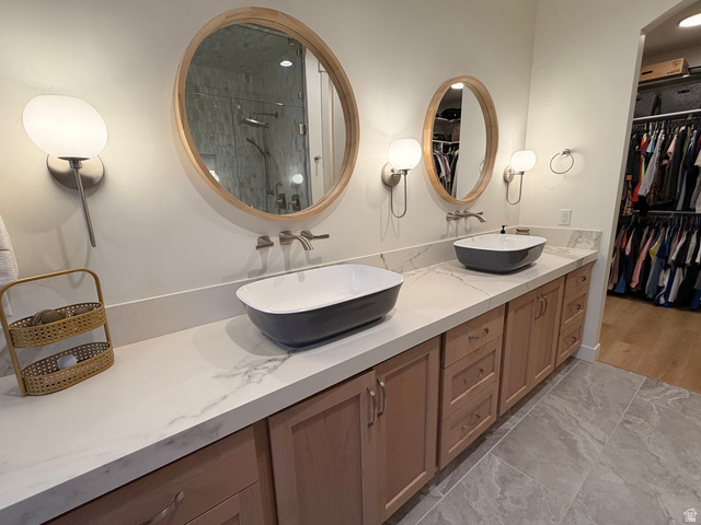 3626 Riverstone Road Mapleton, UT 84664 - Photo 21 of 58 Full bath with double vanity, a stall shower, light marble finish floors, and a spacious closet