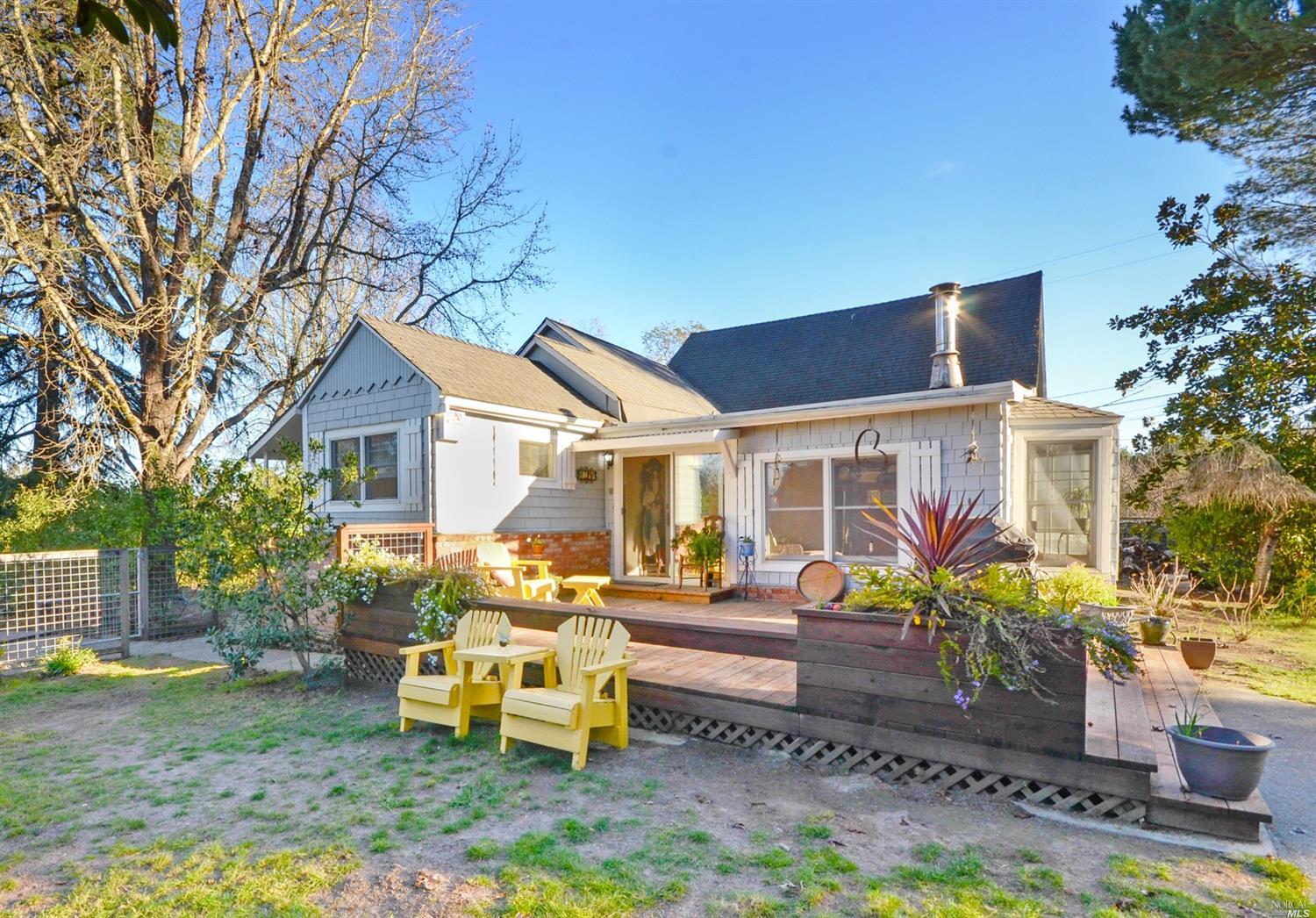 2196 Laguna Road Santa Rosa, CA 95401 - Photo 1 of 1 a view of a house with backyard sitting area and garden