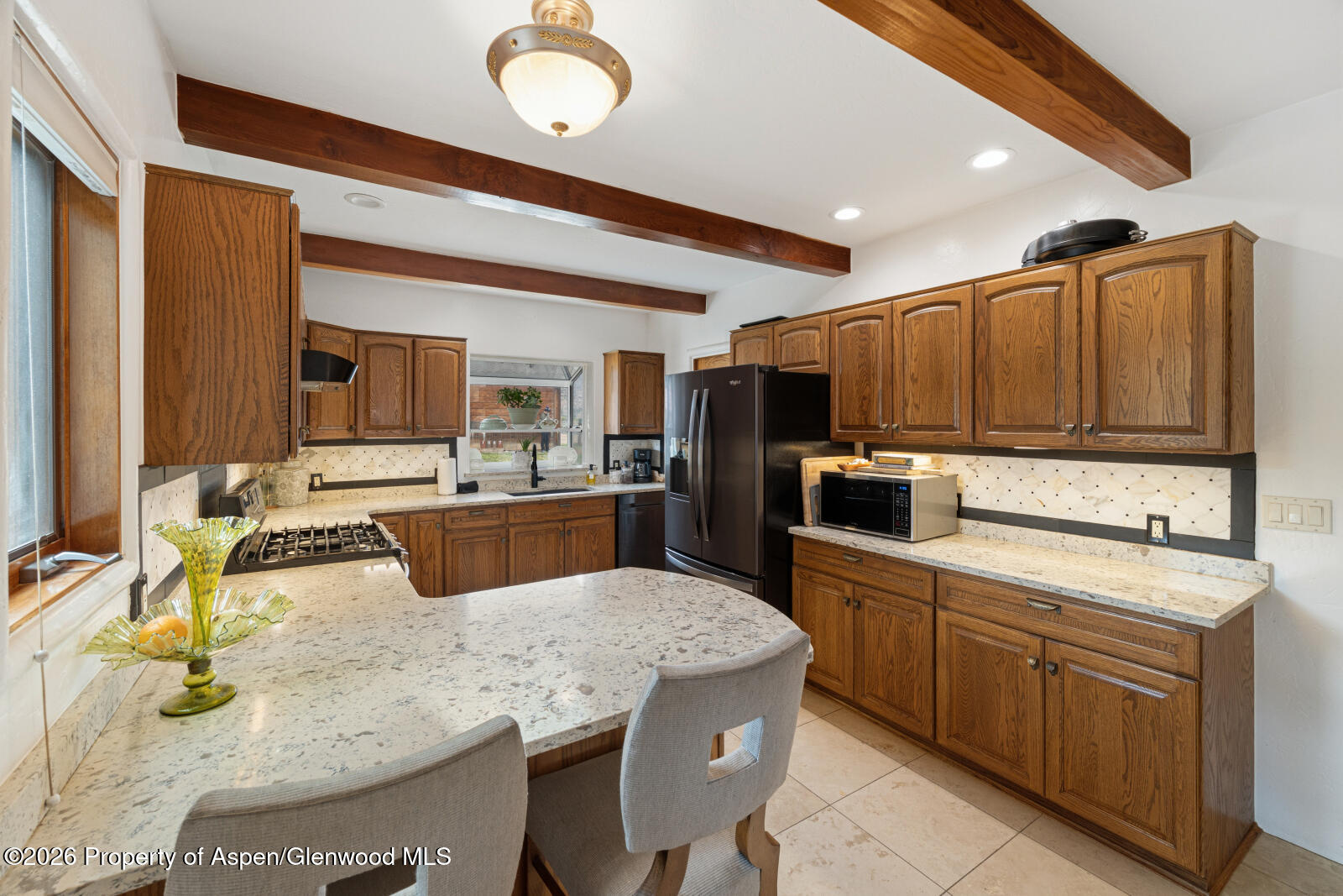 1007 Mesa Drive Rifle, CO 81650 - Photo 18 of 56 a kitchen with kitchen island granite countertop a sink counter top space appliances and cabinets