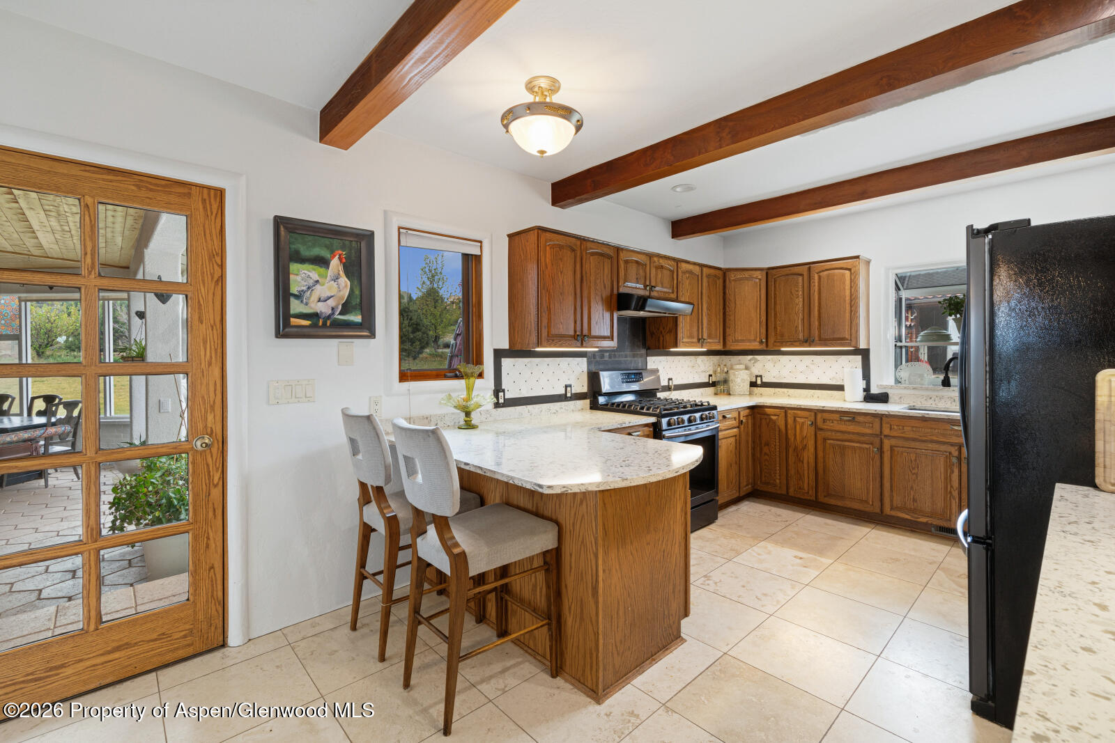1007 Mesa Drive Rifle, CO 81650 - Photo 19 of 56 a kitchen with a refrigerator a sink and dishwasher with a dining table