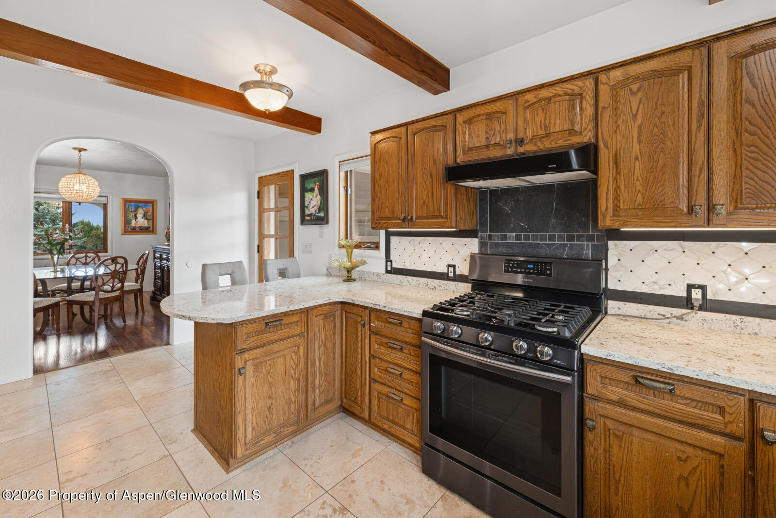 1007 Mesa Drive Rifle, CO 81650 - Photo 20 of 56 a kitchen with stainless steel appliances granite countertop a stove a sink dishwasher and cabinets with wooden floor