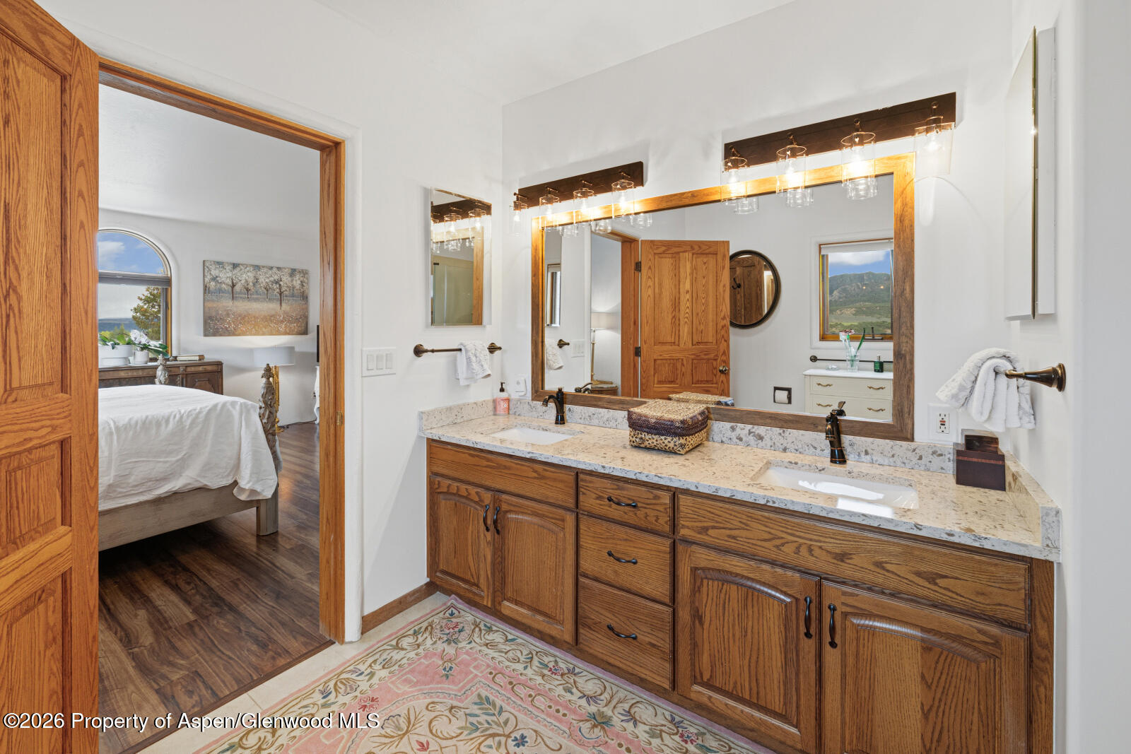 1007 Mesa Drive Rifle, CO 81650 - Photo 33 of 56 a en suite bathroom with double vanity and a mirror