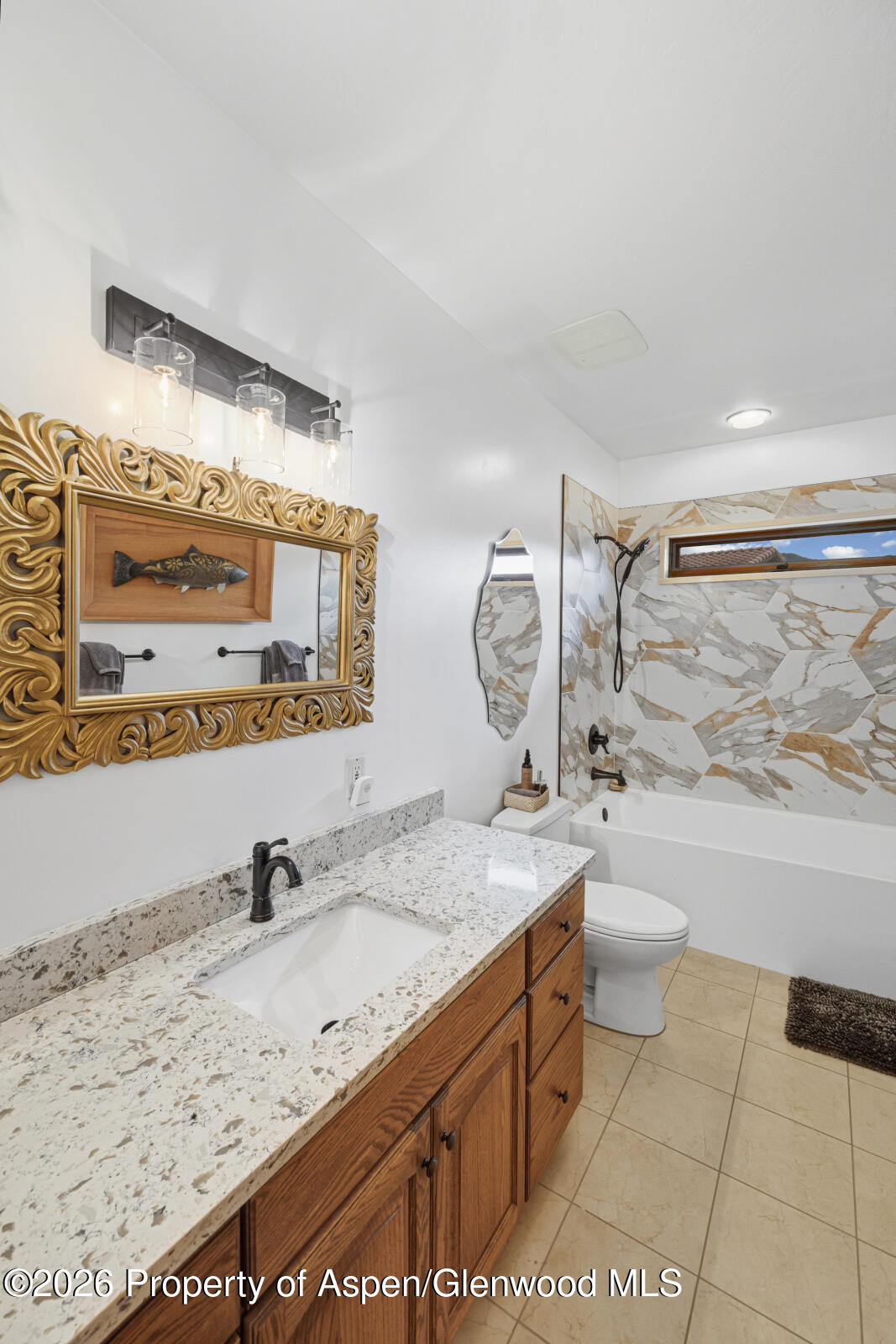 1007 Mesa Drive Rifle, CO 81650 - Photo 36 of 56 a bathroom with a granite countertop sink mirror vanity bathtub and toilet