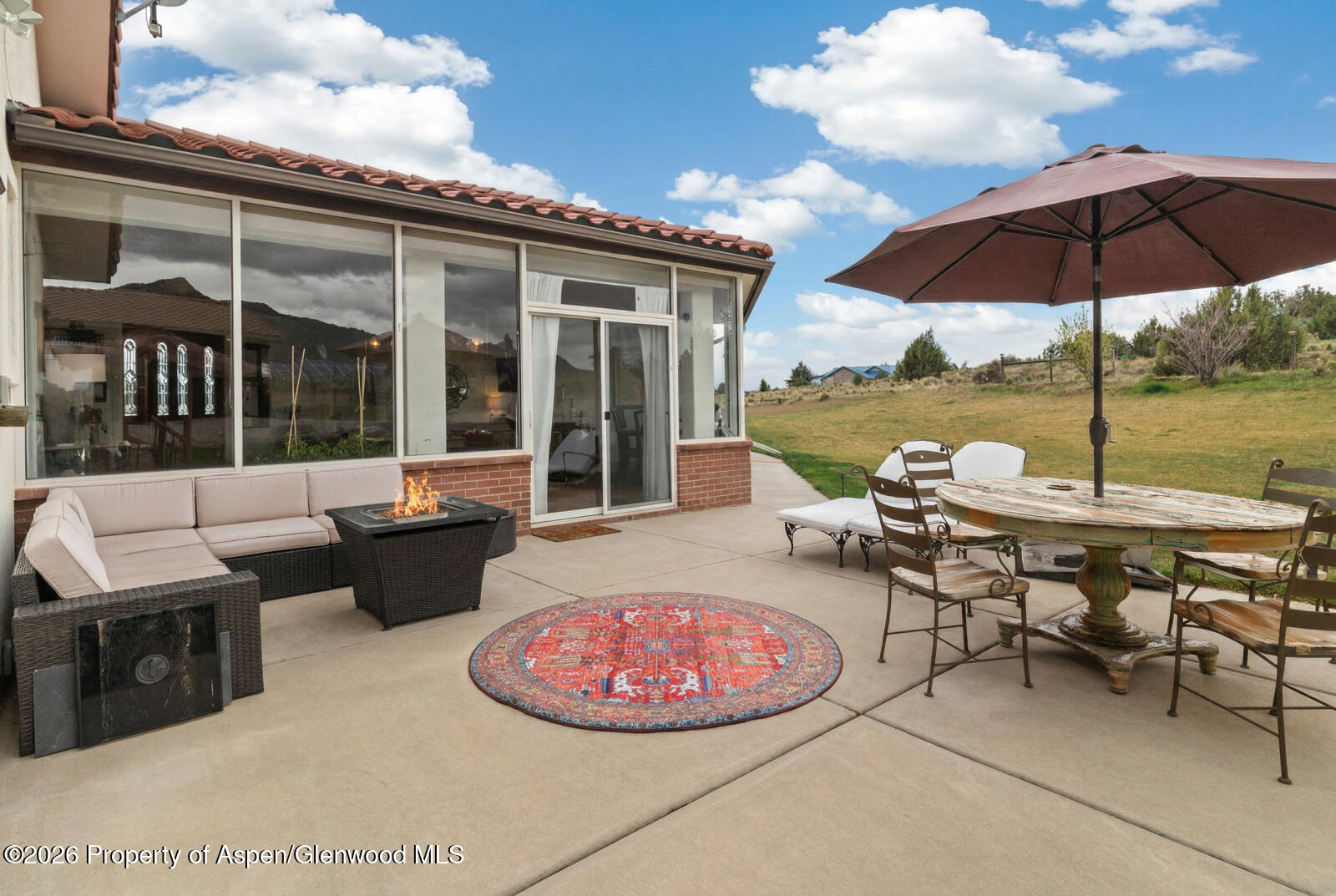 1007 Mesa Drive Rifle, CO 81650 - Photo 41 of 56 a view of a patio with table and chairs under an umbrella