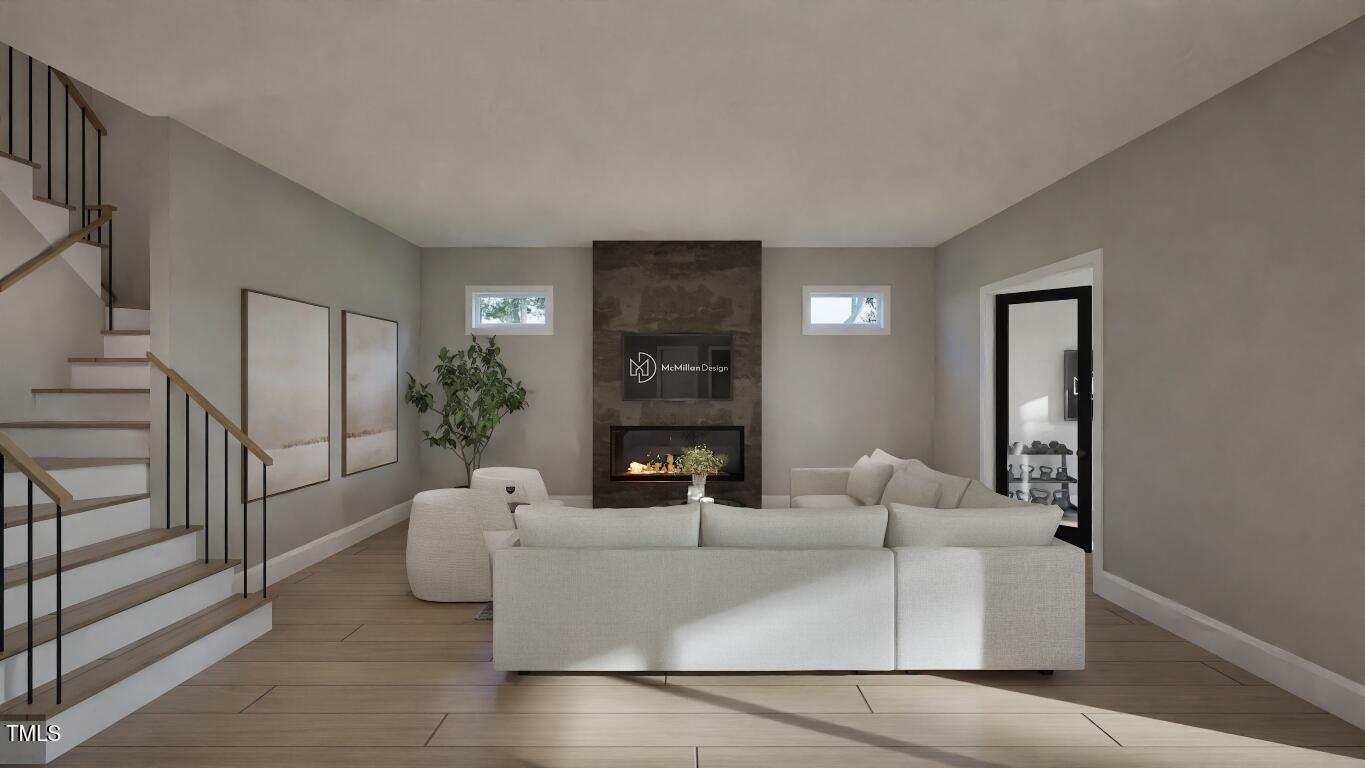 913 Tyrrell Road Raleigh, NC 27609 - Photo 23 of 42 a living room with furniture and a fireplace