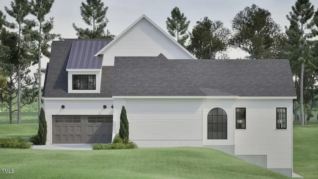 an aerial view of a house with a yard and a large tree