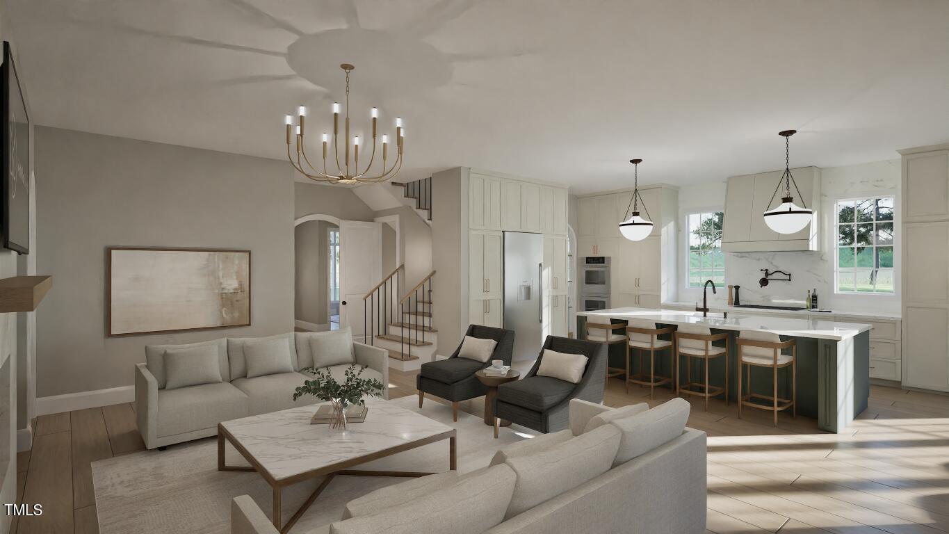 913 Tyrrell Road Raleigh, NC 27609 - Photo 9 of 42 a living room with lots of furniture kitchen view and a chandelier