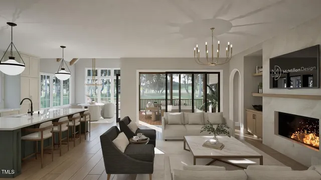 a living room with furniture a chandelier and a fireplace