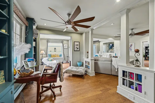 a living room with furniture and a book shelf