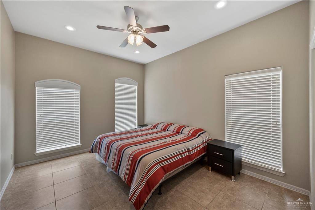 2715 Mimosa Street, Unit 9 Mission, TX 78574 - Photo 12 of 21 a bedroom with a bed and a chandelier