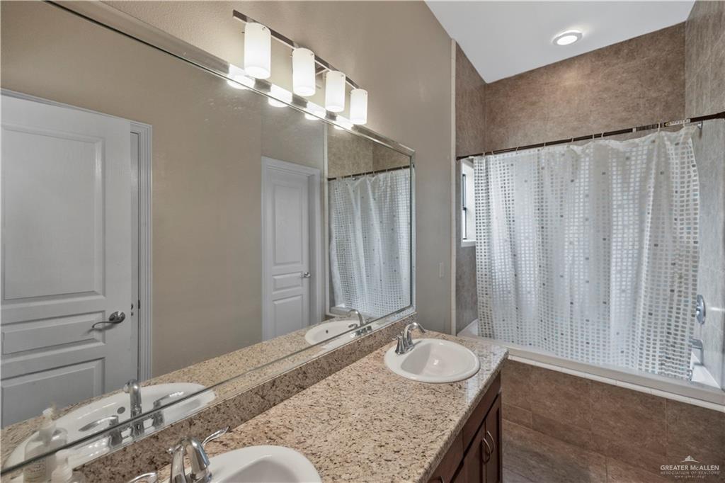 2715 Mimosa Street, Unit 9 Mission, TX 78574 - Photo 13 of 21 a bathroom with a granite countertop sink and a mirror