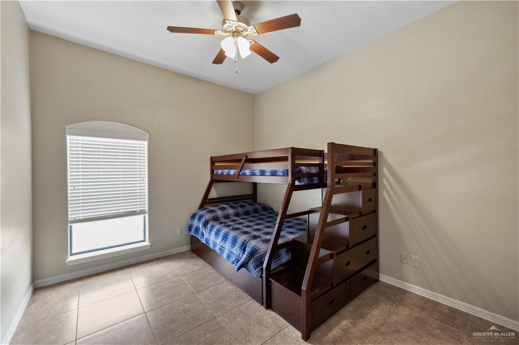 2715 Mimosa Street, Unit 9 Mission, TX 78574 - Photo 15 of 21 a bedroom with a bed and a chandelier