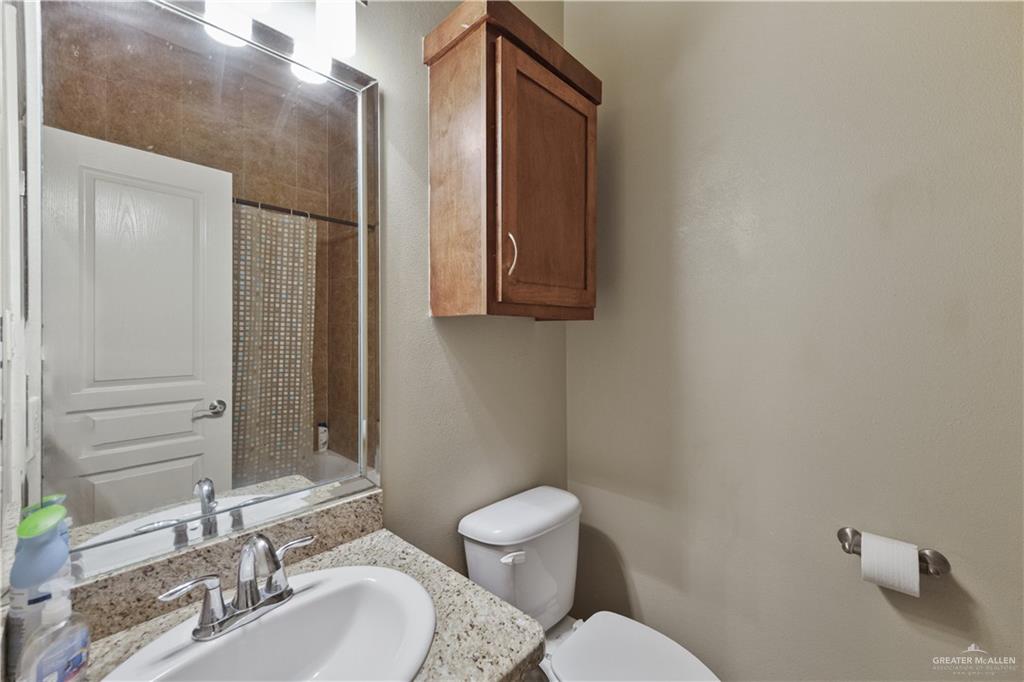 2715 Mimosa Street, Unit 9 Mission, TX 78574 - Photo 17 of 21 a bathroom with a toilet sink and mirror