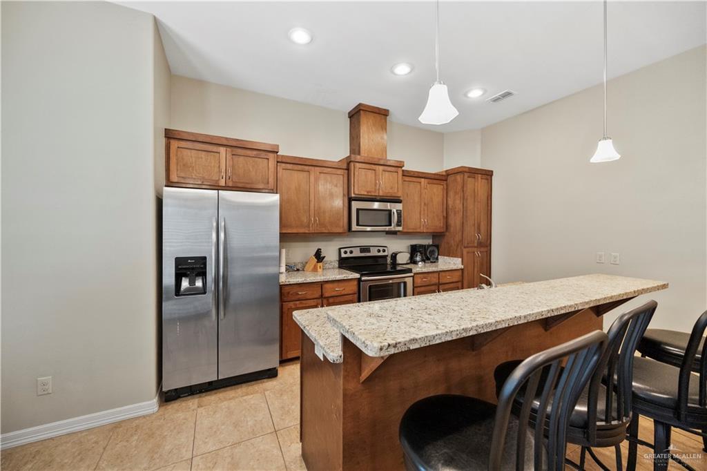 2715 Mimosa Street, Unit 9 Mission, TX 78574 - Photo 6 of 21 a kitchen with cabinets and stainless steel appliances