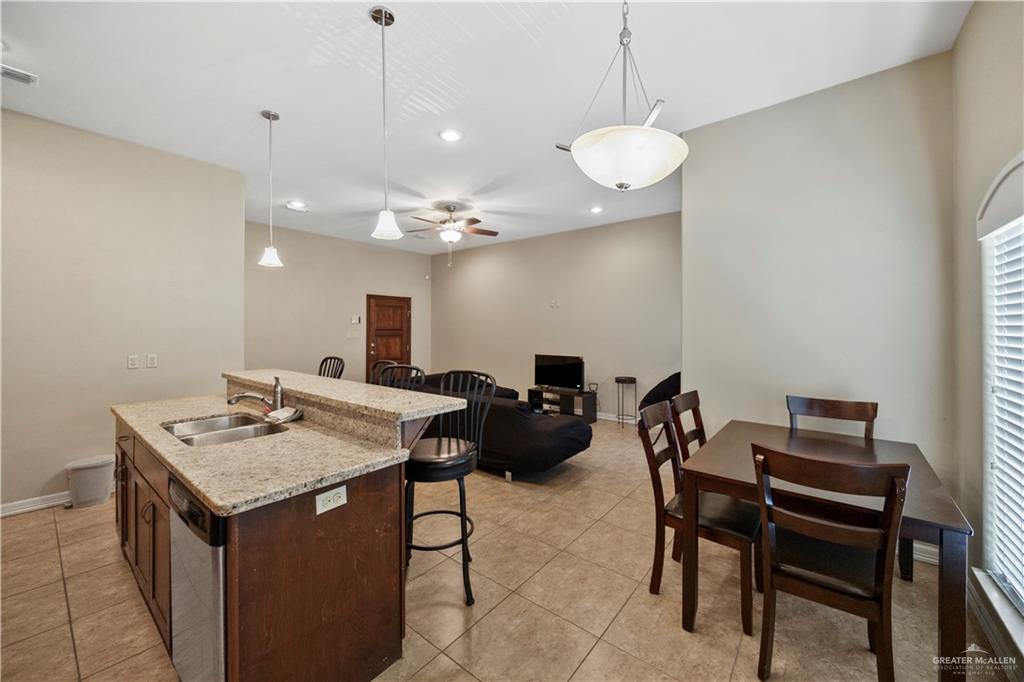 2715 Mimosa Street, Unit 9 Mission, TX 78574 - Photo 7 of 21 a view of a dining room with furniture and chandelier