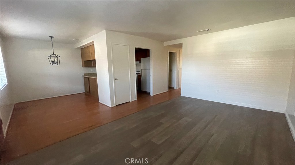 2560 Gonzaga Lane Riverside, CA 92507 - Photo 11 of 52 an empty room with wooden floor and windows