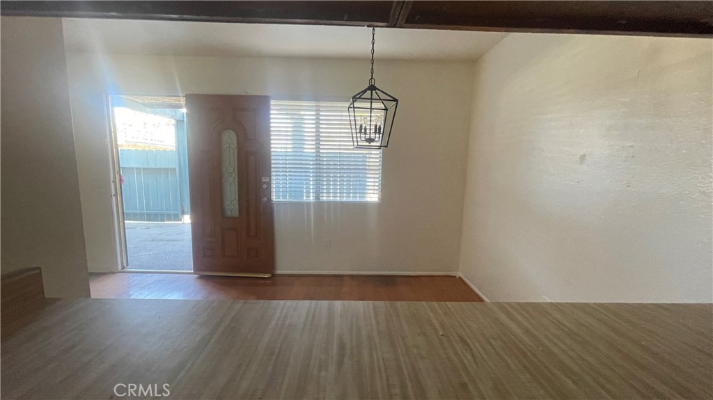 2560 Gonzaga Lane Riverside, CA 92507 - Photo 13 of 52 an empty room with wooden floor and windows