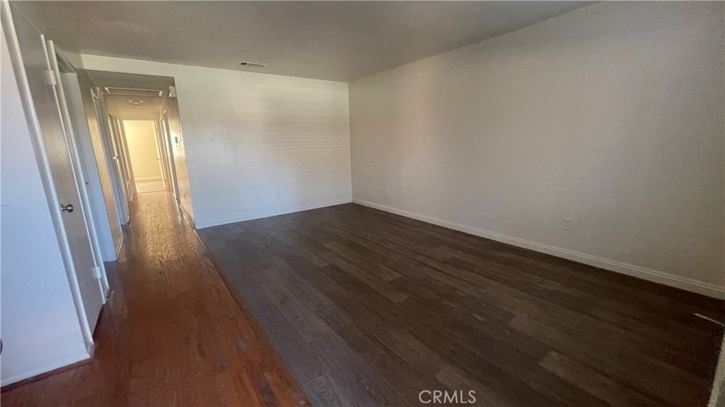 2560 Gonzaga Lane Riverside, CA 92507 - Photo 14 of 52 an empty room with wooden floor and windows