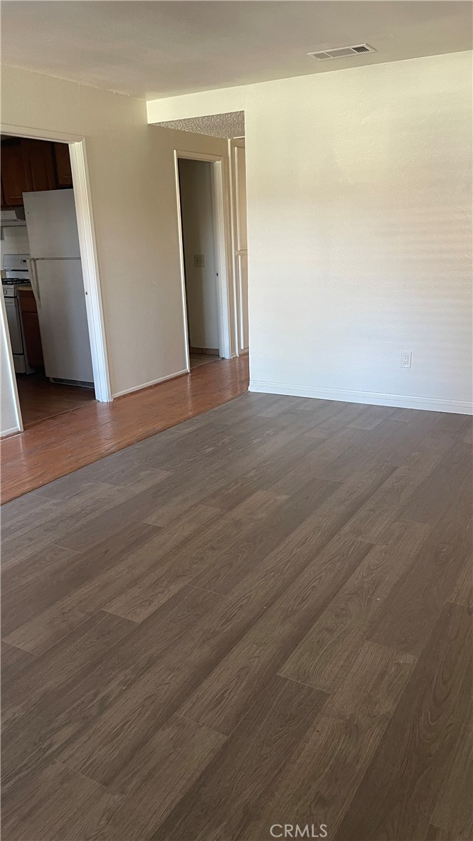 2560 Gonzaga Lane Riverside, CA 92507 - Photo 23 of 52 a view of an empty room with wooden floor and a window