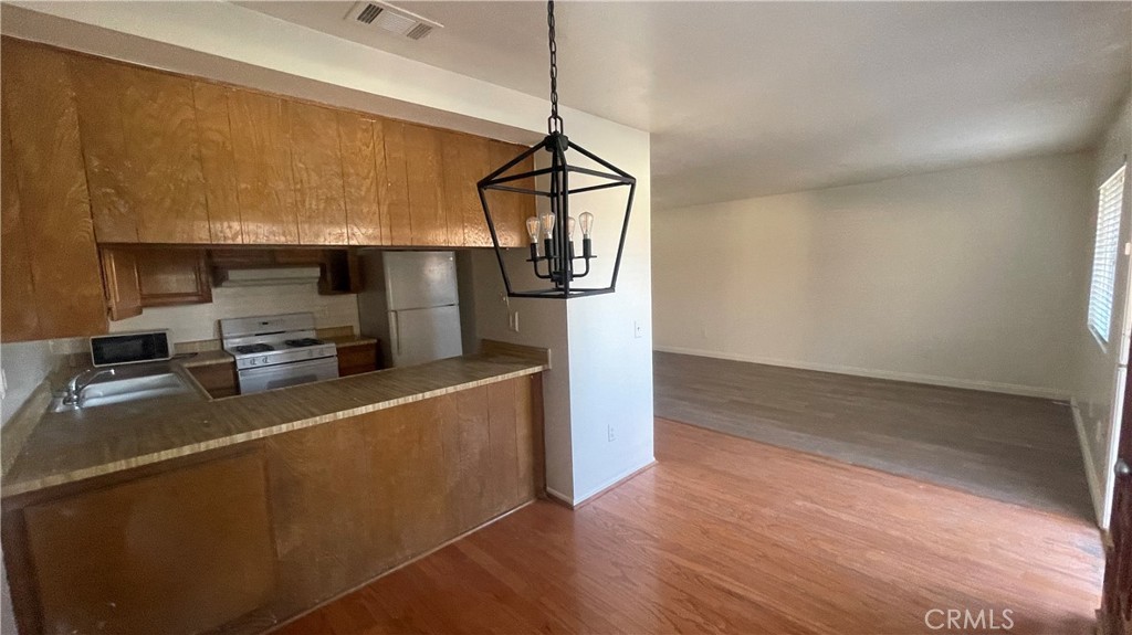 2560 Gonzaga Lane Riverside, CA 92507 - Photo 7 of 52 a kitchen with stainless steel appliances granite countertop a refrigerator a sink and a stove