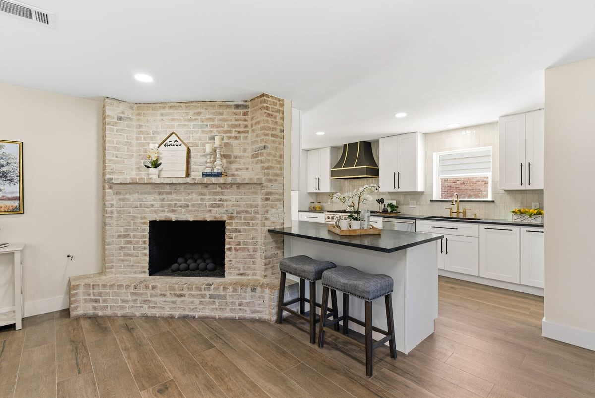 12510 Deep Spring Lane Houston, TX 77077 - Photo 37 of 37 The living room connects to the kitchen and dining room, providing an ideal floor plan for entertaining or enjoying a cozy evening at home!
