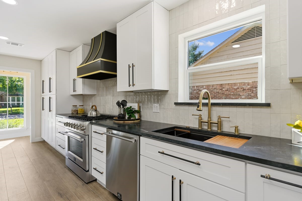 12510 Deep Spring Lane Houston, TX 77077 - Photo 13 of 37 Touches of character provide charm to this stunning kitchen! Unique vent hood, glimmering tile extends to the ceiling, and golden accents provide a beautiful back drop to your gourmet meals!