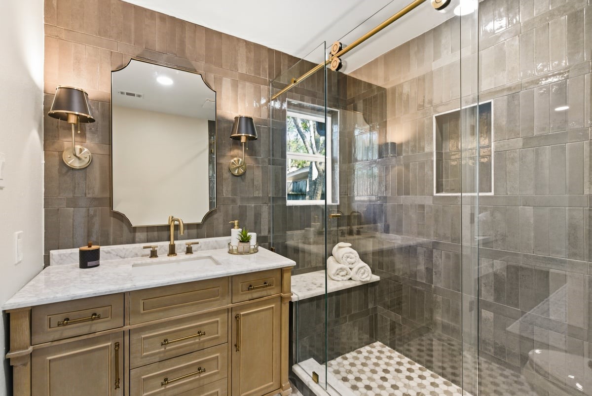 12510 Deep Spring Lane Houston, TX 77077 - Photo 5 of 37 This jaw-dropping bathroom is as beautiful as it is functional! Elegant floor to ceiling tile design compliments the extended counters and large vanity!