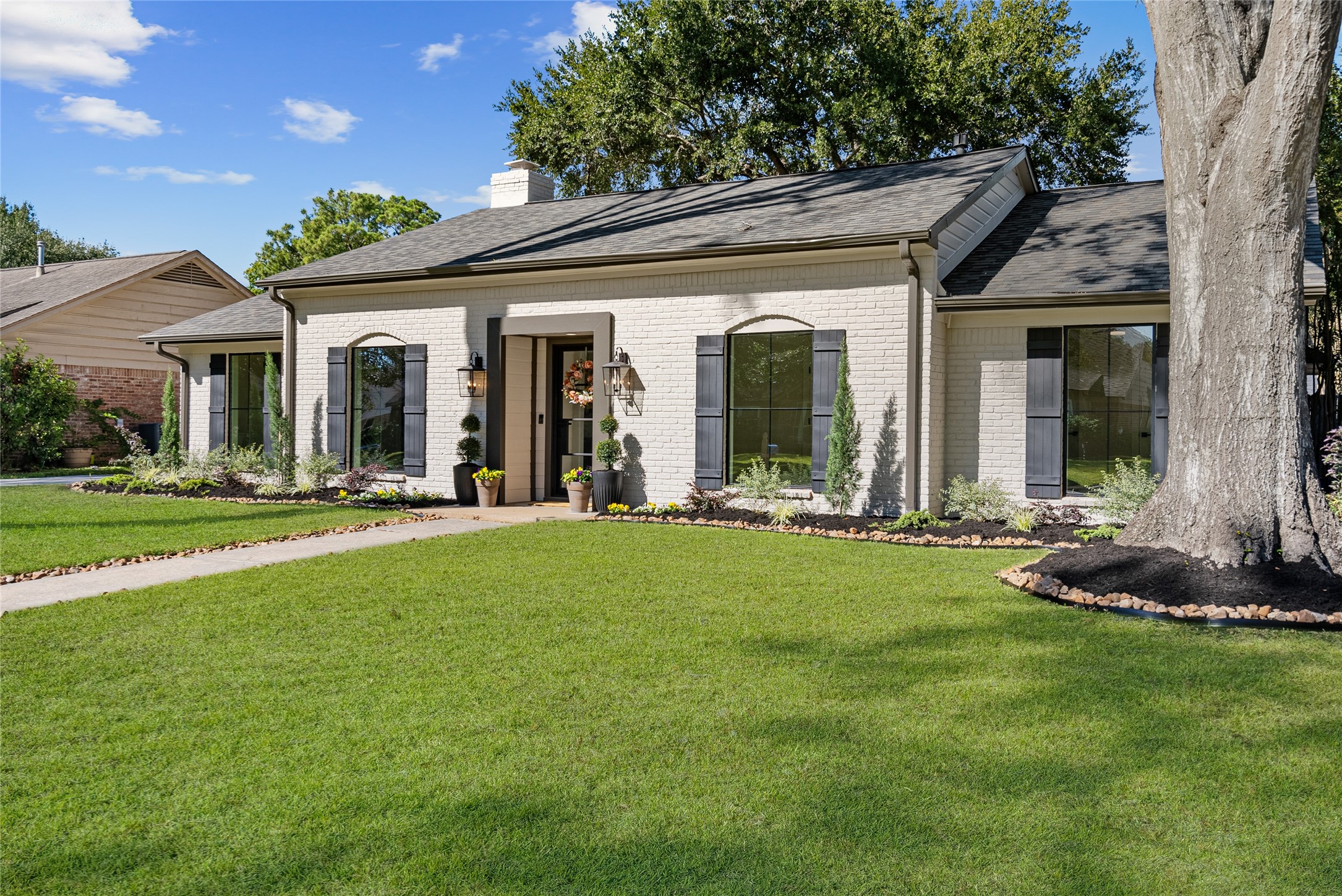12510 Deep Spring Lane Houston, TX 77077 - Photo 6 of 37 Manicured and cheerful landscaping compliment a modern exterior with new door and windows!