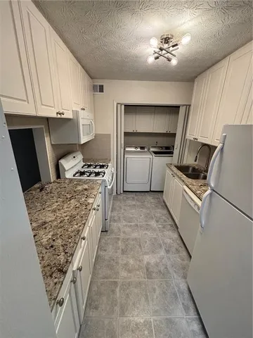 a kitchen with a refrigerator and a stove top oven