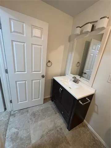 a bathroom with a sink vanity and a mirror