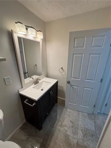 a bathroom with a sink a mirror and vanity