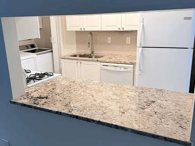 a kitchen with a sink stove and refrigerator