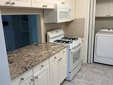 a kitchen with granite countertop cabinets and steel stainless steel appliances