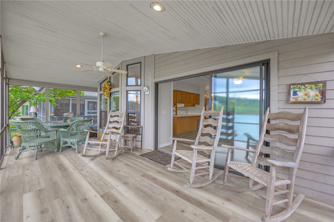 1230 Melton Road, Unit 25 West Union, SC 29696 - Photo 27 of 46 The expansive screened porch offers tranquil lake views, perfect for peaceful mornings or relaxing evenings.