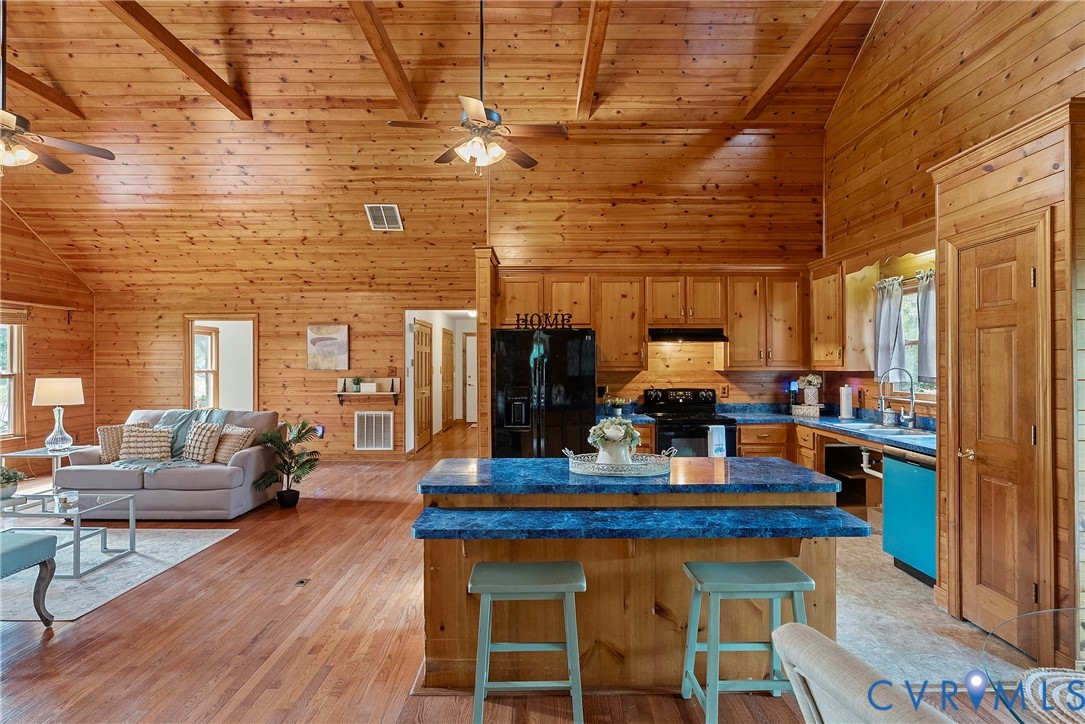 949 Old Buckingham Road Cumberland, VA 23040 - Photo 13 of 49 Kitchen featuring wood walls, black electric range
