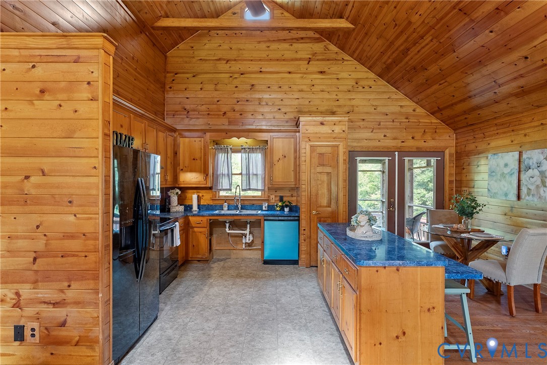 949 Old Buckingham Road Cumberland, VA 23040 - Photo 15 of 49 a kitchen with stainless steel appliances kitchen island granite countertop a refrigerator and wooden cabinets