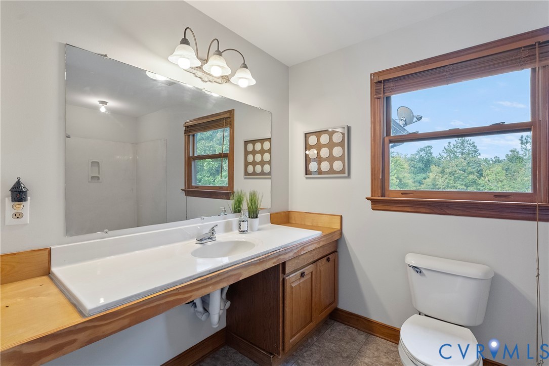 949 Old Buckingham Road Cumberland, VA 23040 - Photo 20 of 49 Bedroom featuring wood-type flooring, a fireplace,