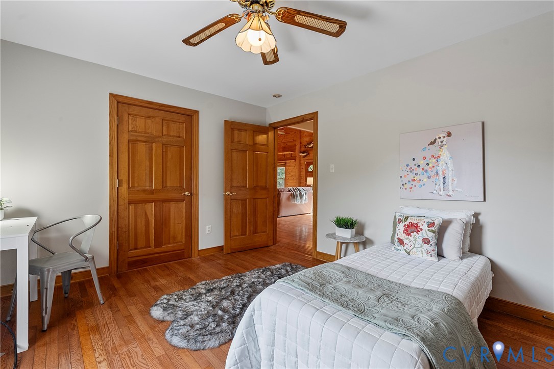 949 Old Buckingham Road Cumberland, VA 23040 - Photo 29 of 49 a bedroom with a large bed and wooden floor