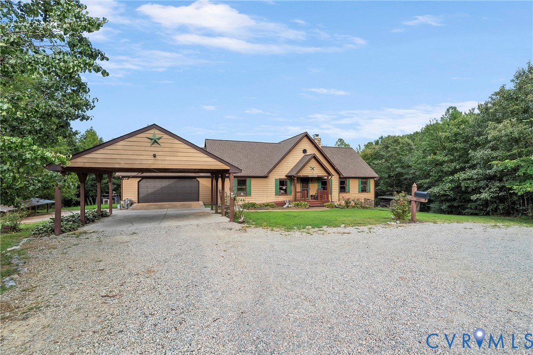 949 Old Buckingham Road Cumberland, VA 23040 - Photo 5 of 49 a front view of a house with a yard and garage