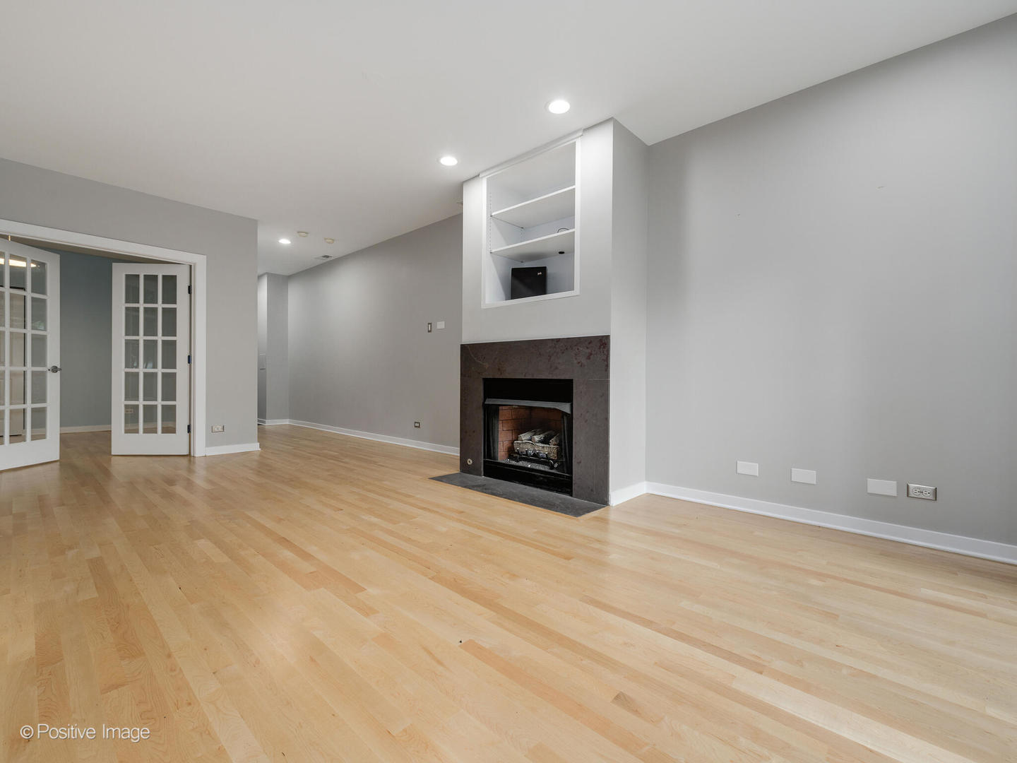 1834 West Rice Street, Unit A Chicago, IL 60622 - Photo 15 of 23 a view of an empty room with wooden floor fireplace and a window