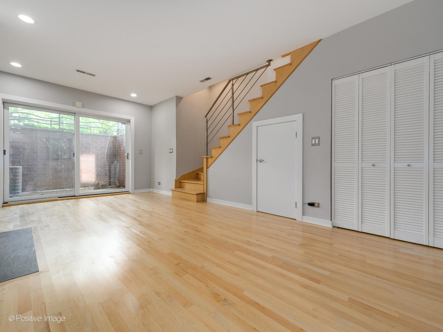 1834 West Rice Street, Unit A Chicago, IL 60622 - Photo 17 of 23 a view of an empty room with wooden floor and stairs