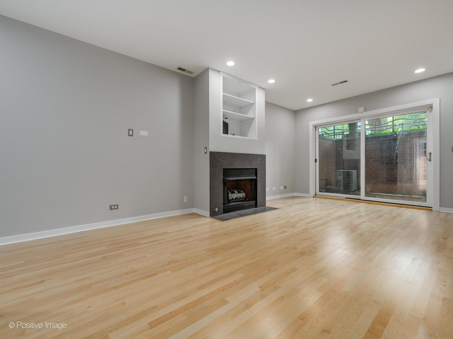 1834 West Rice Street, Unit A Chicago, IL 60622 - Photo 18 of 23 a view of an empty room with a fireplace and a window