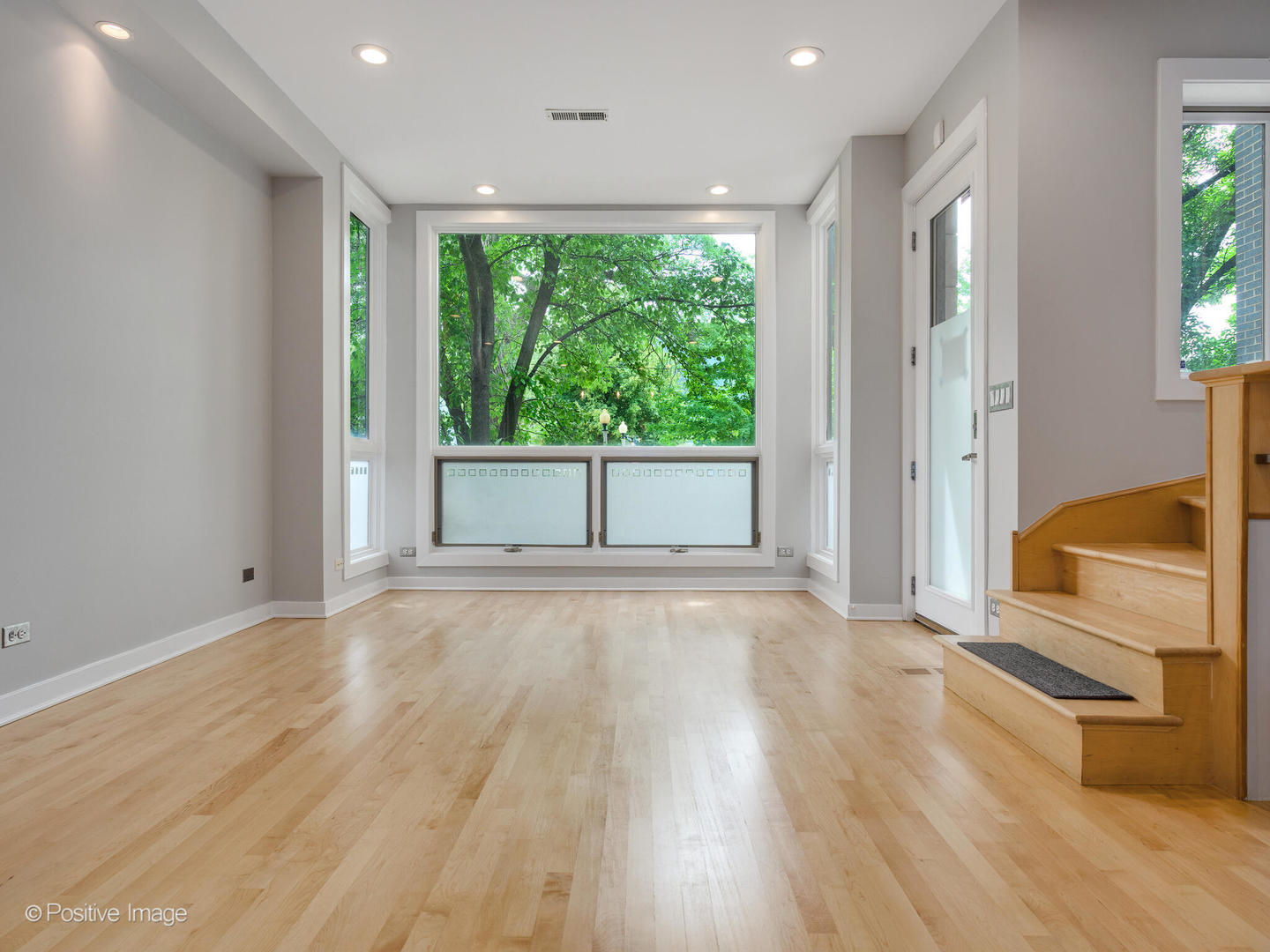 1834 West Rice Street, Unit A Chicago, IL 60622 - Photo 4 of 23 an empty room with wooden floor and windows