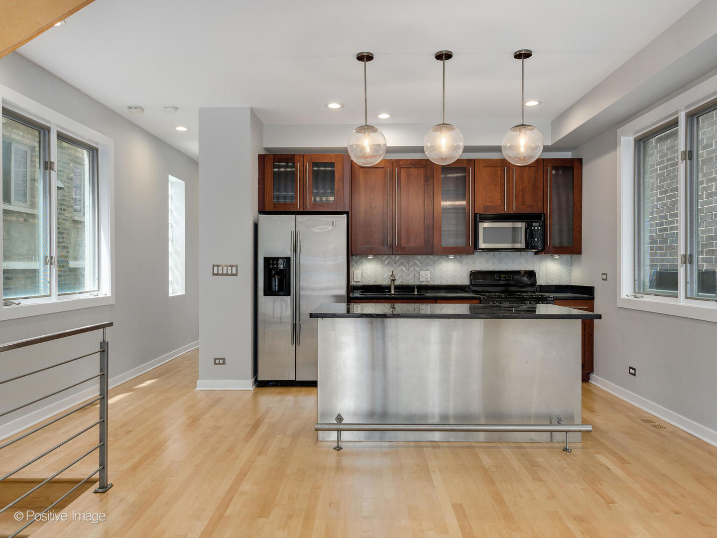 1834 West Rice Street, Unit A Chicago, IL 60622 - Photo 5 of 23 a kitchen with stainless steel appliances granite countertop a refrigerator a stove a sink and a microwave
