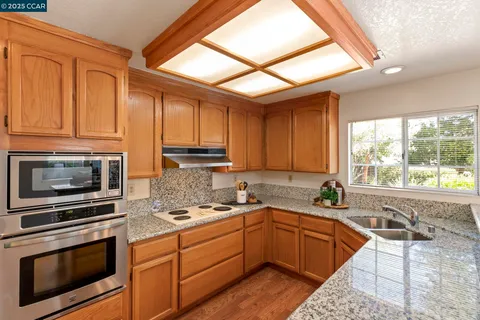 a kitchen with a sink and a large window